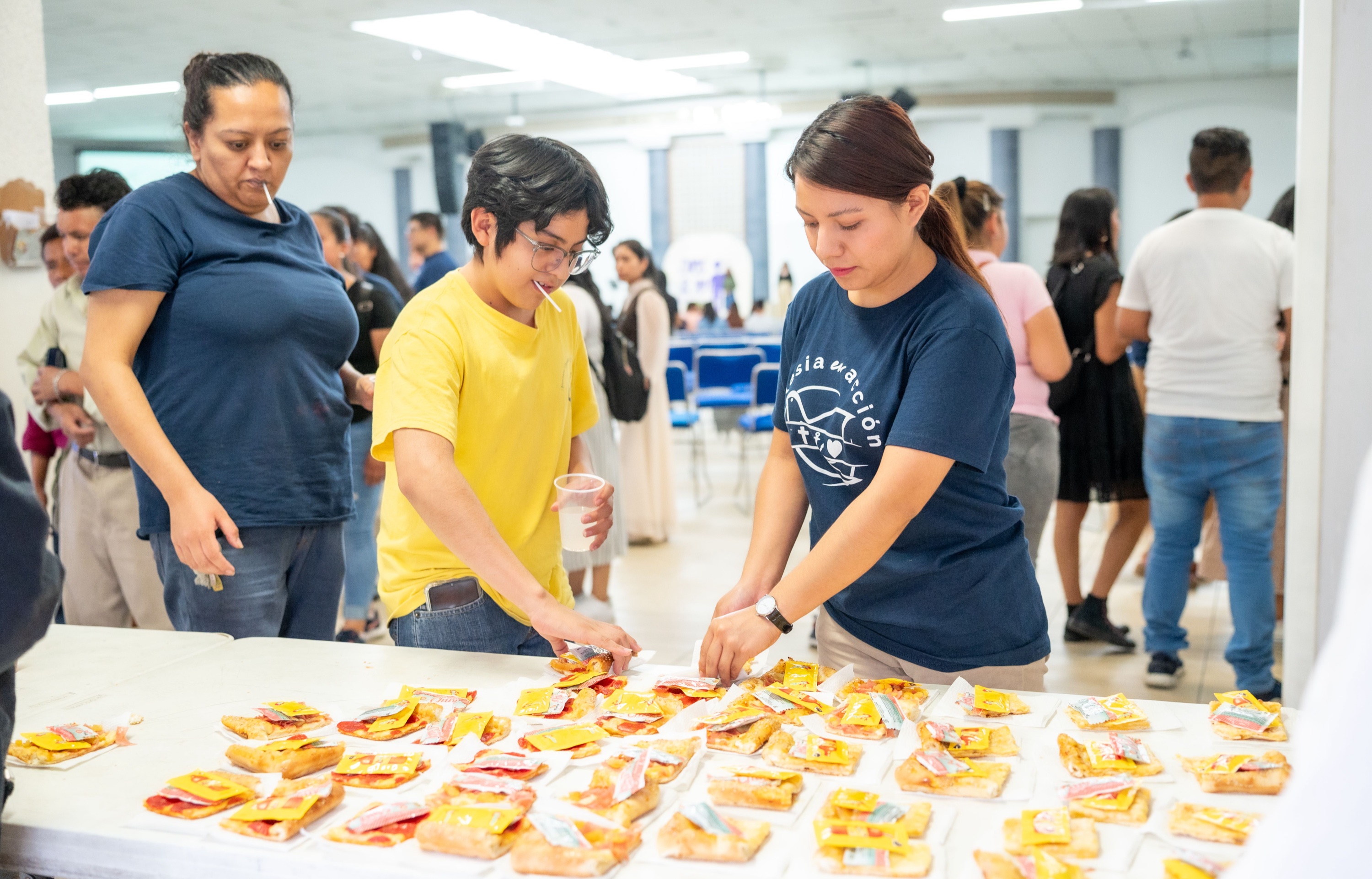Church and community volunteers serving food together at a gathering
