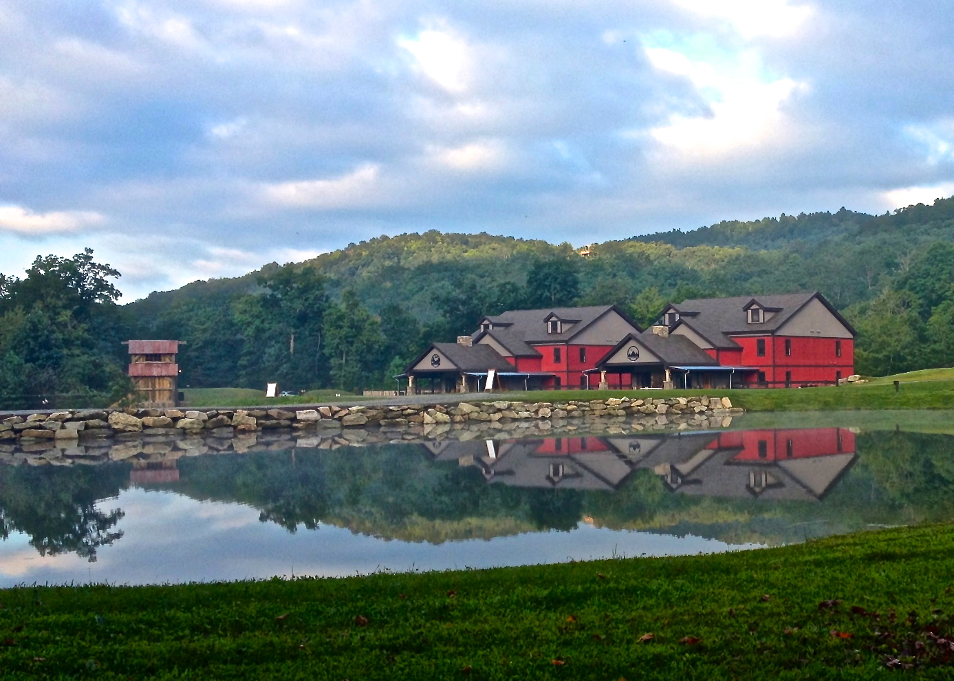 Camp buildings reflected in a lake